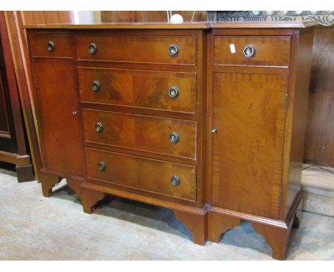 A reproduction Georgian style breakfront side cupboard fitted with a T shaped arrangement of six drawers flanked by cupboards