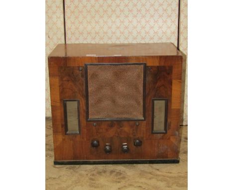 A vintage "His Masters Voice" walnut cased mains radio with Bakelite handles 