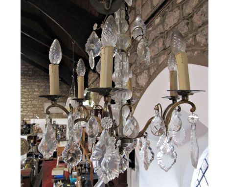 A Regency style glass bodies chandelier with six branches and glass droplets 