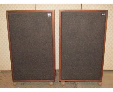 A pair of Heathkit hi-fi speakers model AS-9530 with teak veneered cases and raised on shepherds type castors 