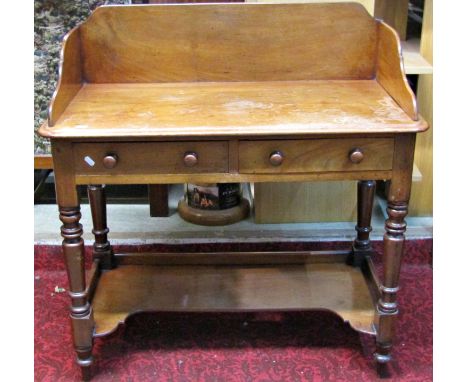 A Victorian mahogany washstand with raised three quarter splashback over two frieze drawers raised on ring turned and tapered