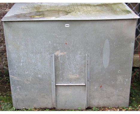 A light galvanised tin bunker of rectangular form with rising lid and small central sliding door, 116 cm wide x 71 cm deep x 