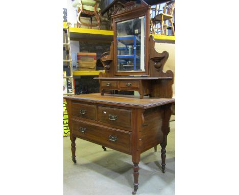 A Victorian walnut dressing table, the raised swing mirror with rectangular bevelled edge plate beneath an architectural pedi