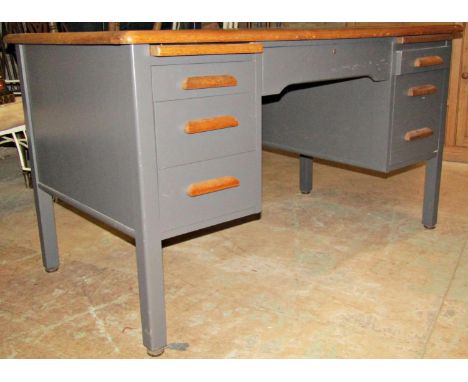 A vintage oak kneehole desk with partially later but tastefully painted finish and fitted with an arrangement of seven frieze