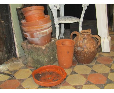 A small quantity of terracotta flower pots, square tapered planter and three handled jar 