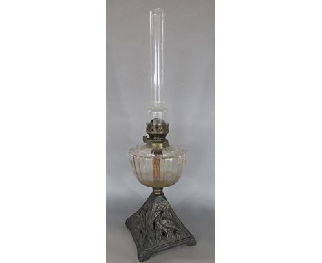 A Falks oil lamp, cast iron base with wading herons, lacks shade 