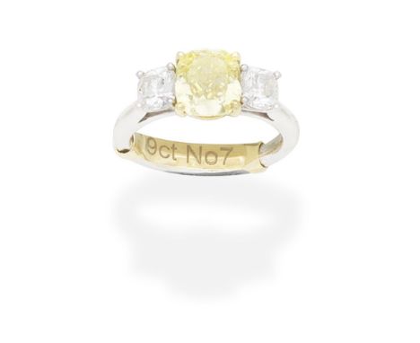 FANCY COLOURED DIAMOND AND DIAMOND RINGThe Fancy Intense Yellow cushion-shaped diamond, weighing 2.09 carats, between similar