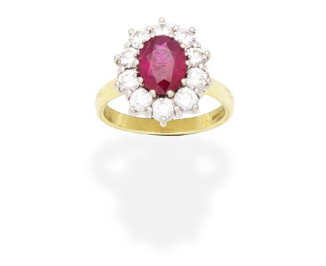 RUBY AND DIAMOND CLUSTER RINGThe oval-cut ruby within a brilliant-cut diamond surround, mounted in 18 carat gold, diamonds ap