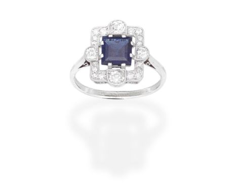 SAPPHIRE AND DIAMOND RINGThe step-cut sapphire within an openwork frame set with cushion-shaped, old brilliant and single-cut