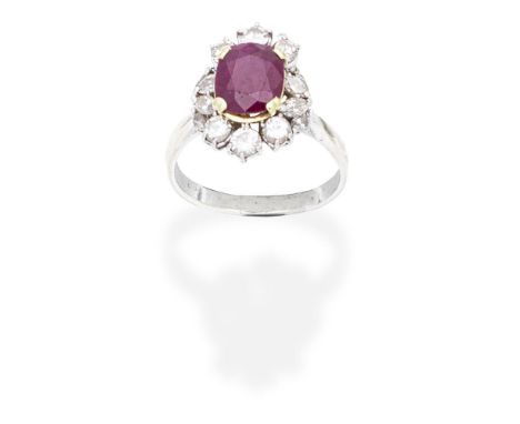 RUBY AND DIAMOND CLUSTER RINGThe cushion-shaped ruby within a brilliant and marquise-cut diamond surround,  diamonds approx. 