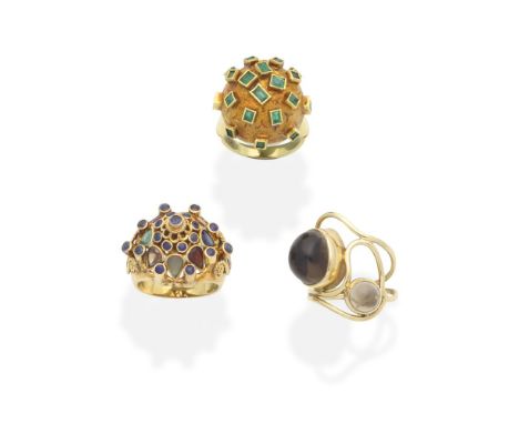 THREE GEM-SET DRESS RINGS1st: Set with step-cut emeralds, 2nd: Set with vari-cut gemstones, including sapphire, emeralds and 