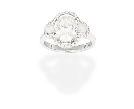 DIAMOND RINGThe oval-cut diamond, weighing 2.51 carats, between rose-cut diamonds, within a brilliant-cut diamond surround, r