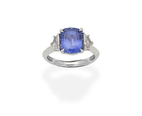 SAPPHIRE AND DIAMOND RING, 2020The cushion-shaped sapphire between two epaulette-cut diamonds, mounted in platinum, London ha