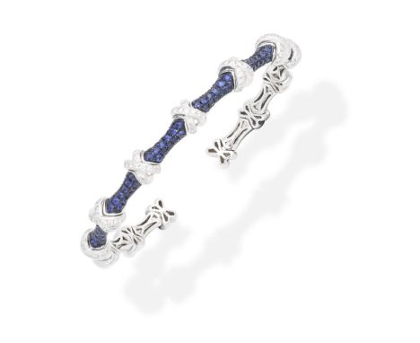 SAPPHIRE AND DIAMOND-SET BANGLEThe sprung torque bangle set to the front with circular-cut sapphires between brilliant-cut di