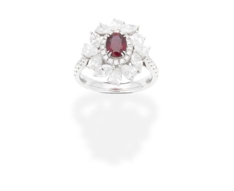 RUBY AND DIAMOND CLUSTER RINGThe oval-cut ruby within a surround of marquise, pear and brilliant-cut diamonds, diamonds appro
