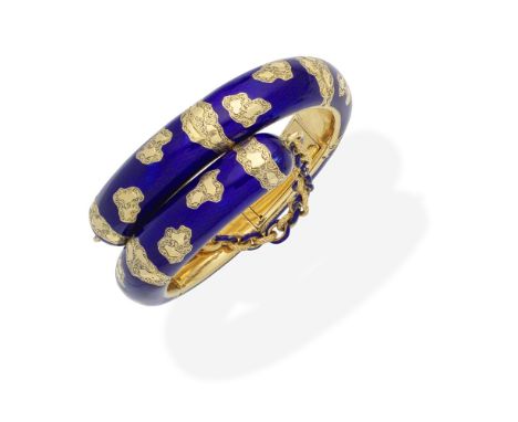 ENAMEL BANGLE, CIRCA 1855The hinged crossover bangle decorated with royal blue guilloche enamel and engraved decoration, with