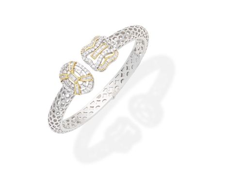 DIAMOND-SET BANGLEThe hinged torque bangle of openwork lattice design, with brilliant and baguette-cut diamond terminals,  in