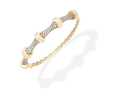 DIAMOND-SET BANGLEOf bicoloured design, the front set with alternating brilliant-cut diamonds and similarly cut diamonds of b