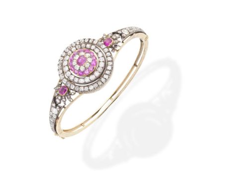 RUBY AND DIAMOND SET BANGLE, CIRCA 1880Of target design, set with a cushion-cut ruby within a similarly cut diamond and ruby 