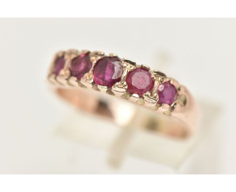 A FIVE STONE RUBY RING, five circular cut rubies prong set in yellow metal leading on to a plain polished shank, unmarked, ri