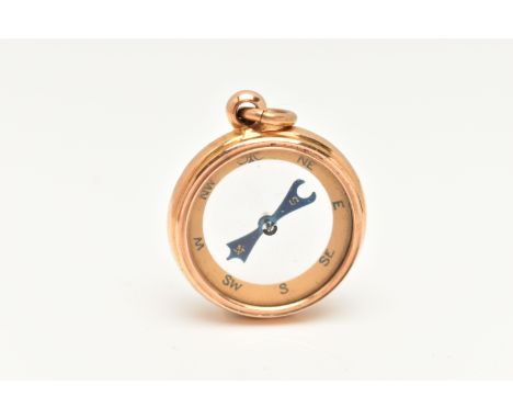 A 15CT GOLD COMPASS PENDANT, circular form yellow gold pendant with glass centre panels, fitted with a bail, approximate widt
