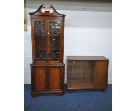 AN EARLY 20TH CENTURY WALNUT CORNER CUPBOARD, with twin swan neck pediment, double astragal glazed doors, above double cupboa
