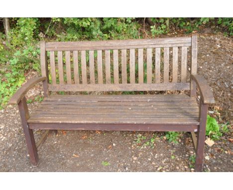 A MODERN HARDWOOD GARDEN BENCH with slatted seat and back, width 139cm
