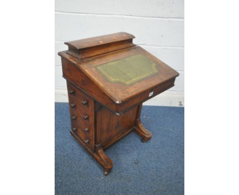 AN VICTORIAN WALNUT DAVENPORT, with a small hinged compartment, a hinged writing slope, with green leather surface, four draw