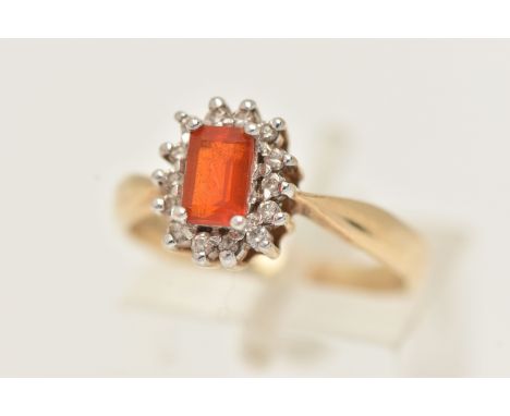 A 9CT GOLD CLUSTER RING, of a rectangular form, set to the centre with a rectangular orange stone, possibly fire opal, four c