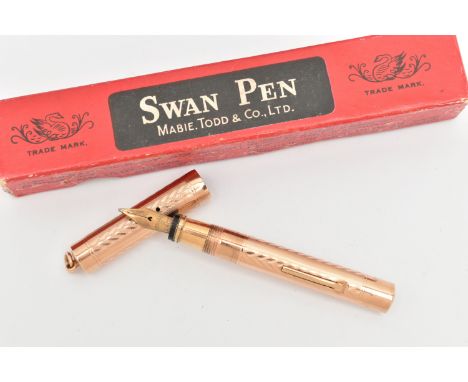 A 'MABIE TODD &amp; CO' YELLOW METAL 'SWAN' FOUNTAIN PEN, a boxed yellow metal fountain pen with engine turned pattern detail