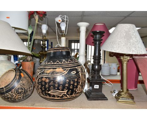 A GROUP OF AFRICAN CARVED GOURD VESSELS, LAMPS AND A STICK STAND, to include a carved gourd vase decorated with mythical crea