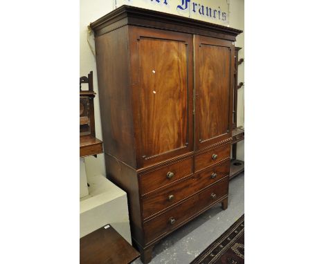 19th Century mahogany two stage linen press cupboard, the moulded cornice above two blind panelled doors, the interior reveal