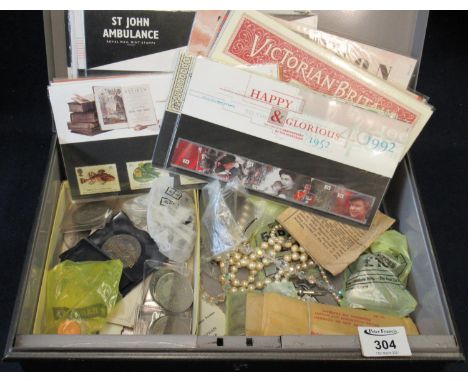 Tin box containing assorted ephemera to include; First Day Covers, assorted coinage, shell shaped spoons, necklaces etc. (B.P