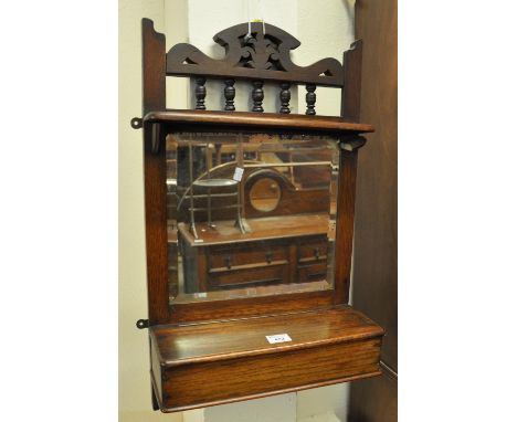 Edwardian oak mirror with shelves and hinged box. (B.P. 21% + VAT)&nbsp;Glass intact but pitted. One shelf bracket is loose.