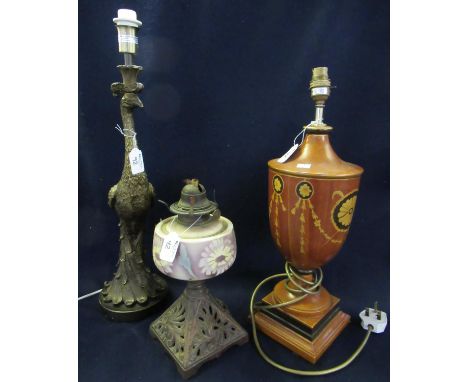 Modern bronzed finish table lamp in the form of a peacock, together with an early 20th Century single oil burner with cast me