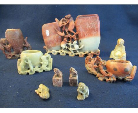Collection of oriental soapstone items to include; desk seals in the form of creatures, brush pots decorated with monkeys etc