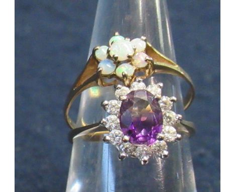 Two 9ct gold dress rings to include an amethyst and opal daisy ring, size O, and another size J 1/2.(B.P. 21% + VAT) 