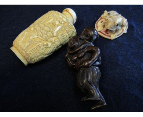 Good quality carved Japanese hardwood netsuke of a young girl with octopus on back and a Japanese ivory netsuke of two frogs 