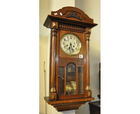 Mid Century mahogany two train wall clock with silvered face, key and pendulum.(B.P. 21% + VAT) 