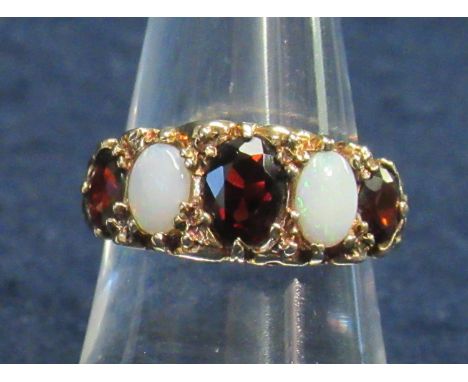 9ct gold opal and garnet dress ring. Ring size O. 3.2g approximately. (B.P. 21% + VAT)&nbsp;Opals have light scratching. Cent