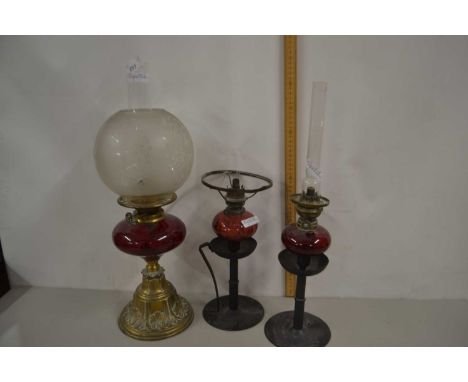 Three oil lamps with ruby glass fonts