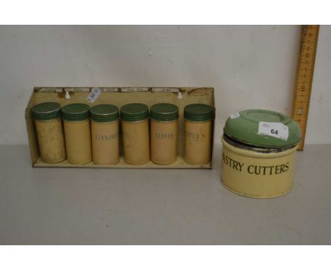 A set of vintage metal kitchen spice pots and a further enamel case of pastry cutters