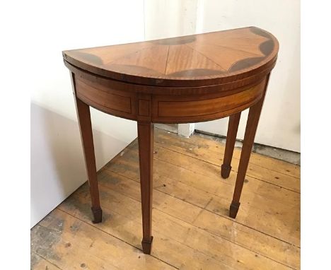 A small George III style satinwood and mahogany demi lune card table c.1900, the foldover top with fan inlay above an inlaid 