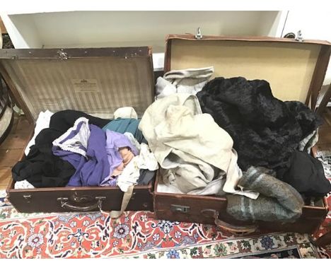Two vintage travelling cases with an assortment of linens