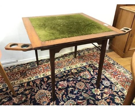 A 1930s/40s oak folding card table with two foldout game piece holders (one pot remaining) on folding legs, bears stamp with 