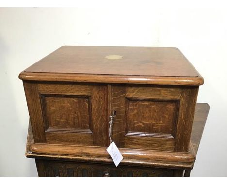 A 1930s oak cutlery canteen with two panel doors enclosing three fitted drawers, complete with a set of Epns including forks,