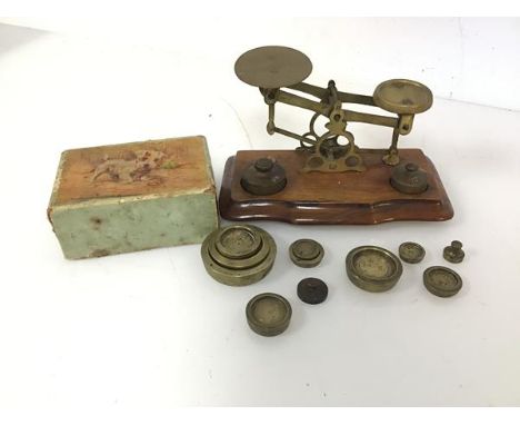 A set of early 20thc brass scales, complete with an assortment of weights and measures (scales: 11cm x 16.5cm x 9cm)
