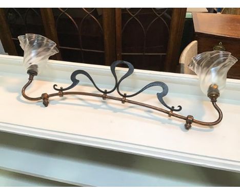 An Edwardian Art Nouveau style pendant light, with metal ribbon crest on copper support, with ruffled vaseline glass shades (