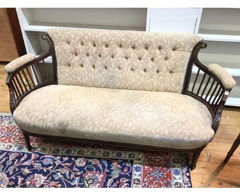 An Edwardian sofa with foliate inlay and modern foliate upholstery, on front tapering supports ending in spade feet (73cm x 1