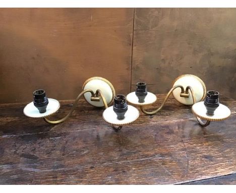 A pair of two arm ceramic and enamelled wall lights, each S scroll arm terminating in a drip tray (14cm x 23cm x 28cm)